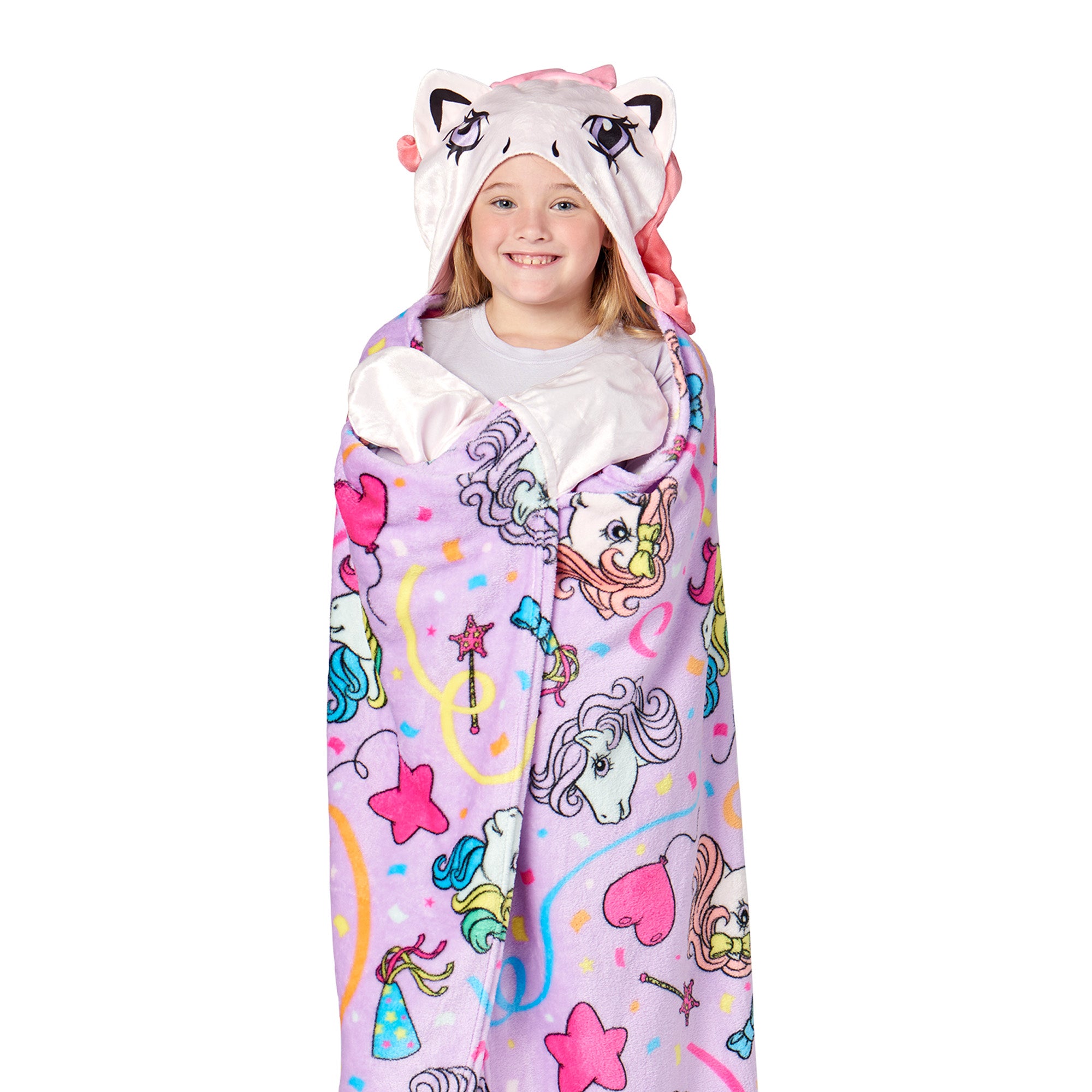 Child wrapped in a colorful unicorn-themed blanket with a white background